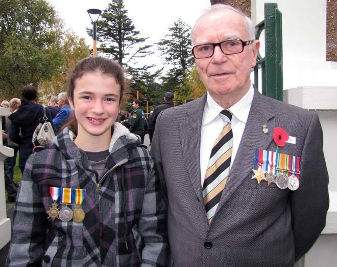 Observing correct medal & poppy wearing protocol ... Holly Moore (12), of Queenstown, wore her great-grandfather's WW1 medals when she walked in the Queenstown Anzac Day parade alongside her grandfather Pat Moore, of Auckland. Photo by Henrietta Kjaer. Source - ODT